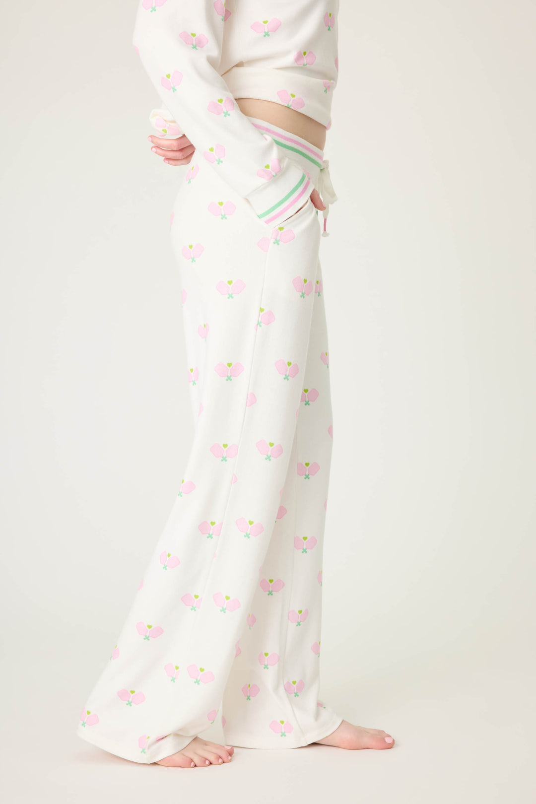 Pickleball racket-printed lounge pant for women in ivory-pink. Side pockets & striped waistband.