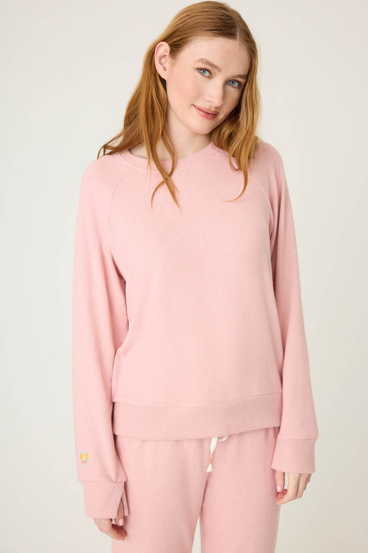 Women's longsleeve pink melange lounge top with small heart embroidery on cuff.