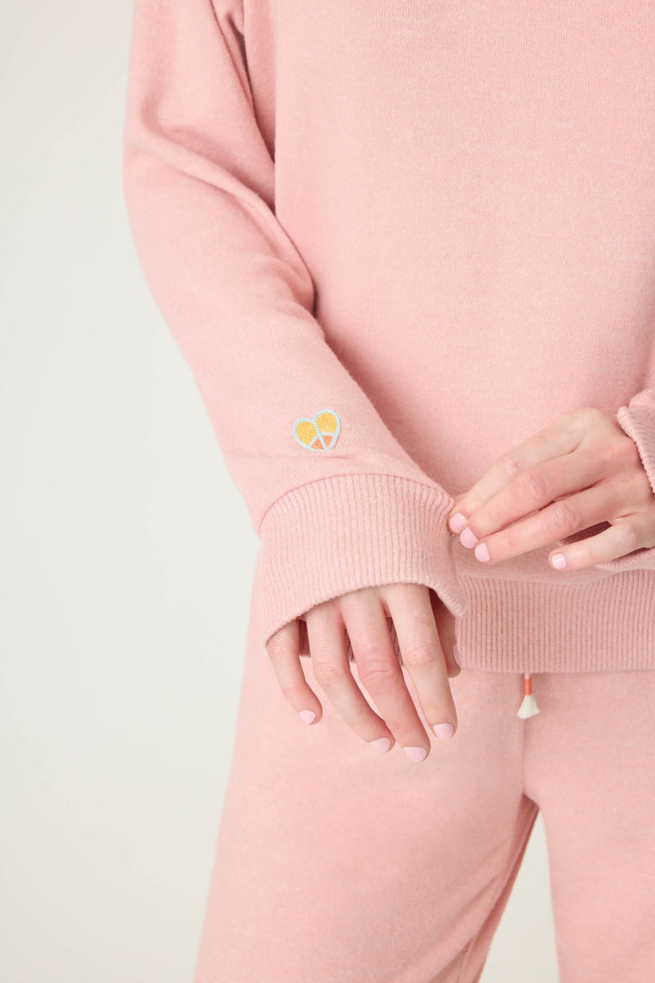 Women's longsleeve pink melange lounge top with small heart embroidery on cuff.
