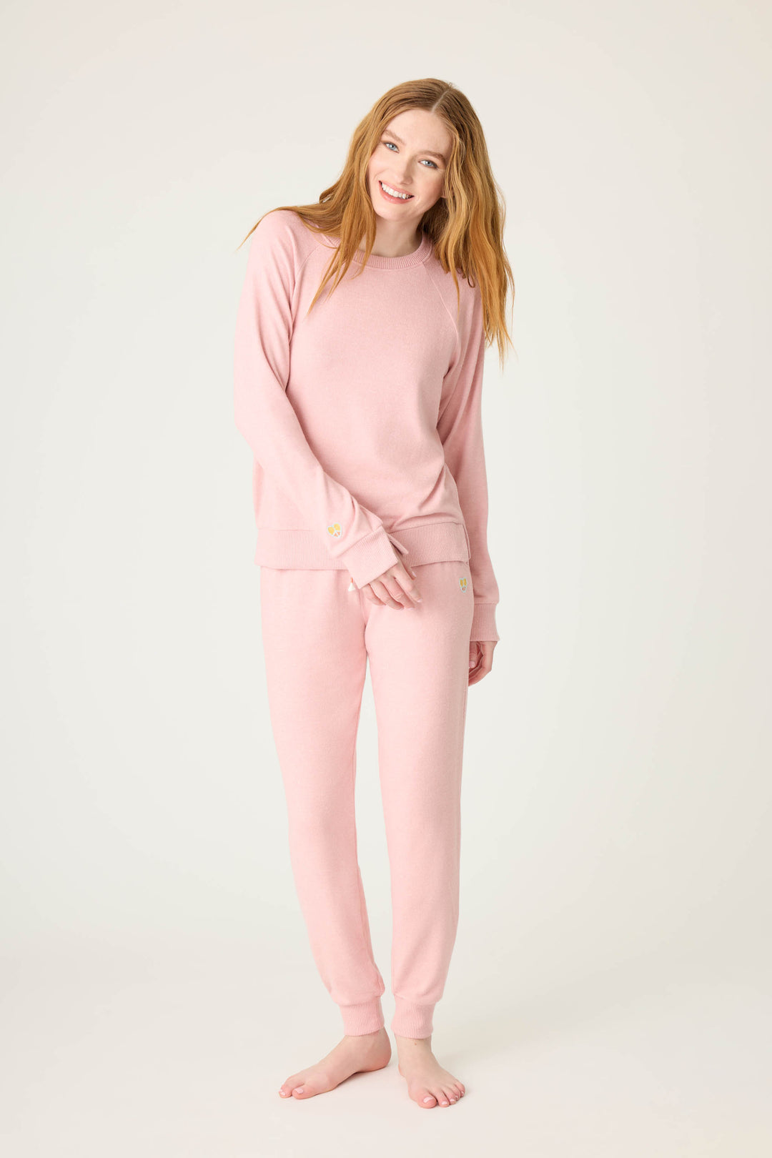 Women's longsleeve pink melange lounge top with small heart embroidery on cuff.