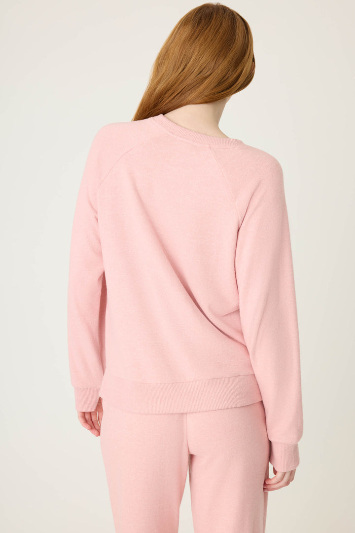Women's longsleeve pink melange lounge top with small heart embroidery on cuff.