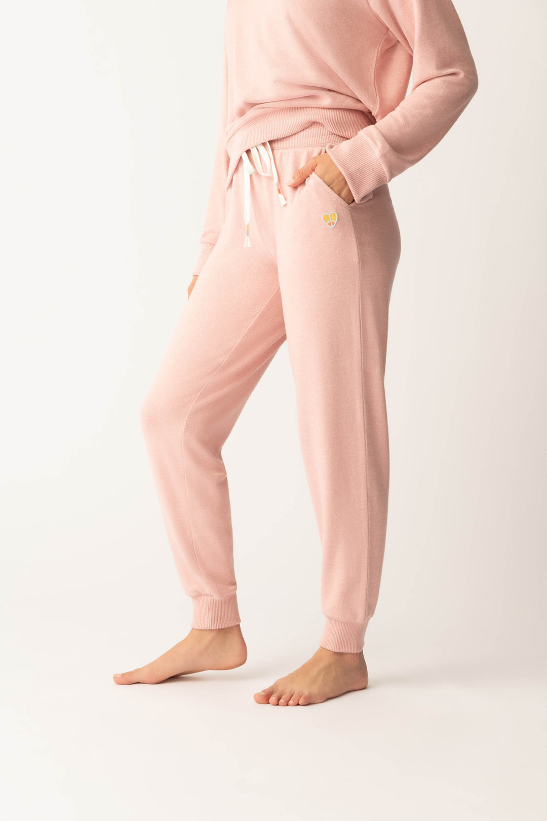 Women's pink melange jogger pant with small heart embroidery on cuff.