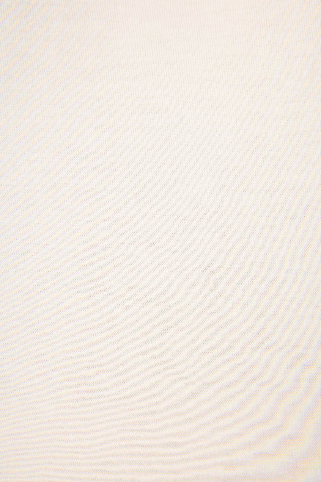 Close-up fabric swatch showing soft ivory knit texture of cotton-blend material.