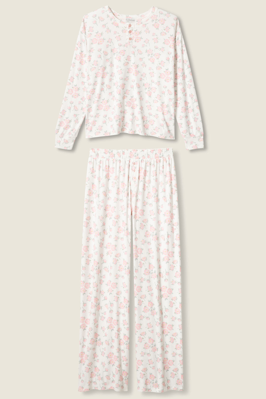 The P.J. Salvage Ivory Floral Print Henley PJ Set features a long-sleeve top with a round neckline and buttons, and full-length pants, both in white with a light pink floral pattern.