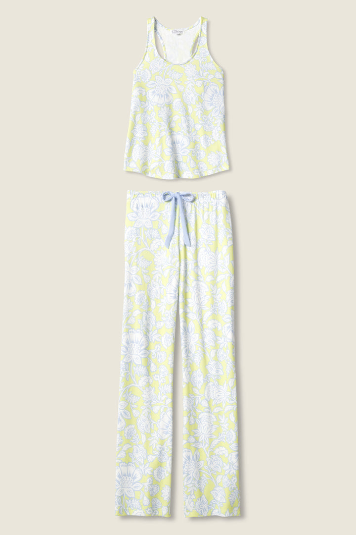 The P.J. Salvage Beautiful Life Floral Print PJ Set features a sleeveless tank top and full-length pants with a light yellow and white floral pattern and a blue drawstring, displayed on a beige background.