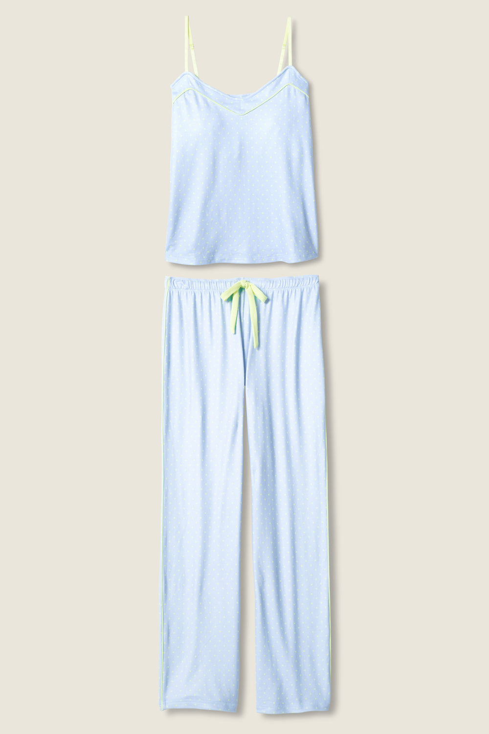 The P.J. Salvage Beautiful Life Polka Dot Pants Set features a light blue sleeveless camisole top with thin straps and long pants with an elastic waistband and yellow drawstring, both with a subtle polka dot pattern.