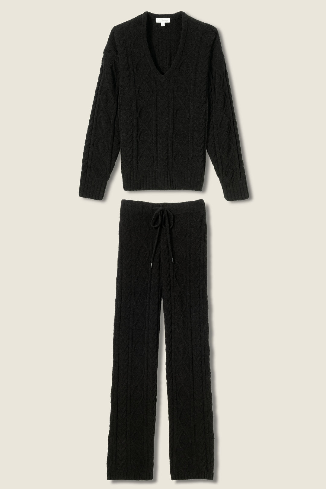 The P.J. Salvage SOLID PJ SET COZY CHENILLE CABLE KNIT, shown in black on a neutral background, features a V-neck long sleeve sweater and relaxed drawstring pants. Both pieces have a cozy cable knit pattern.