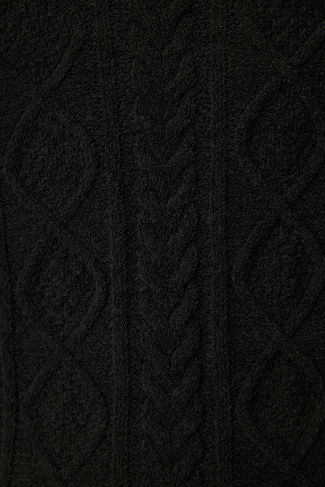 Close-up of the SOLID PJ SET COZY CHENILLE CABLE KNIT by P.J. Salvage, showcasing black cable knit fabric with diamond shapes, braided details, and visible yarn texture.