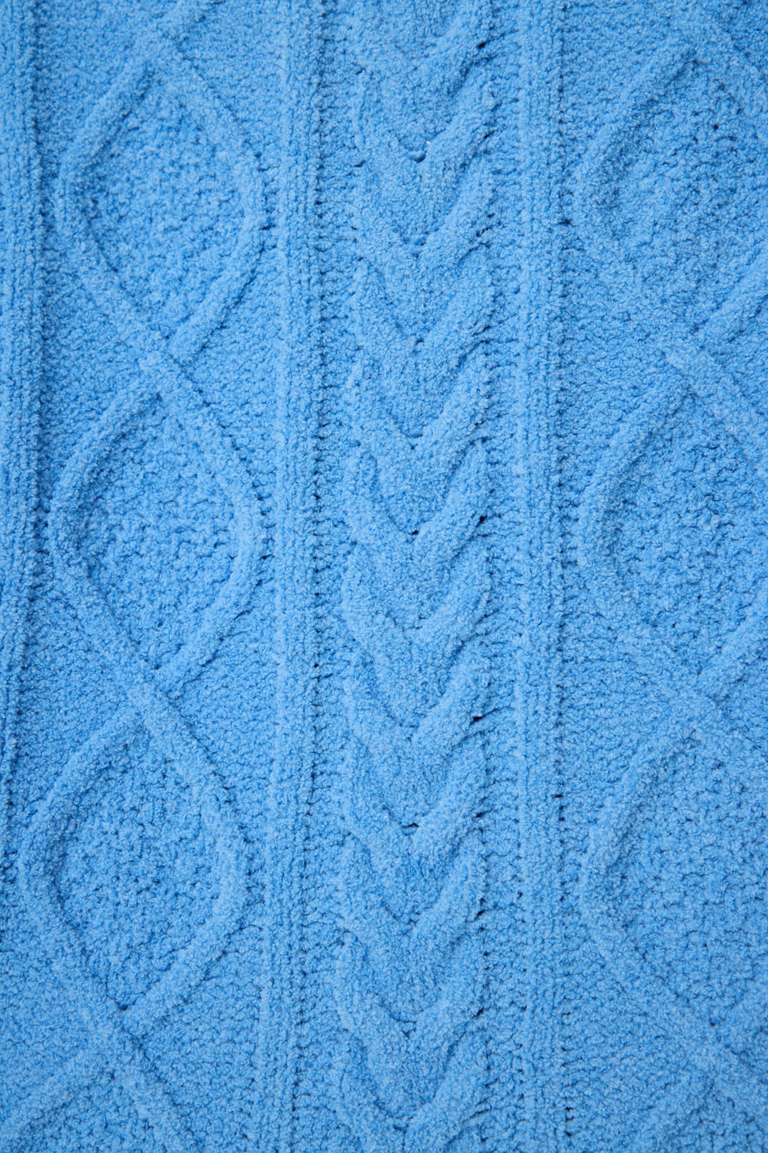 Close-up of the SOLID PJ SET COZY CHENILLE CABLE KNIT by P.J. Salvage, showcasing blue textured fabric with a raised cable knit pattern, braided central design, and diamond shapes on each side.