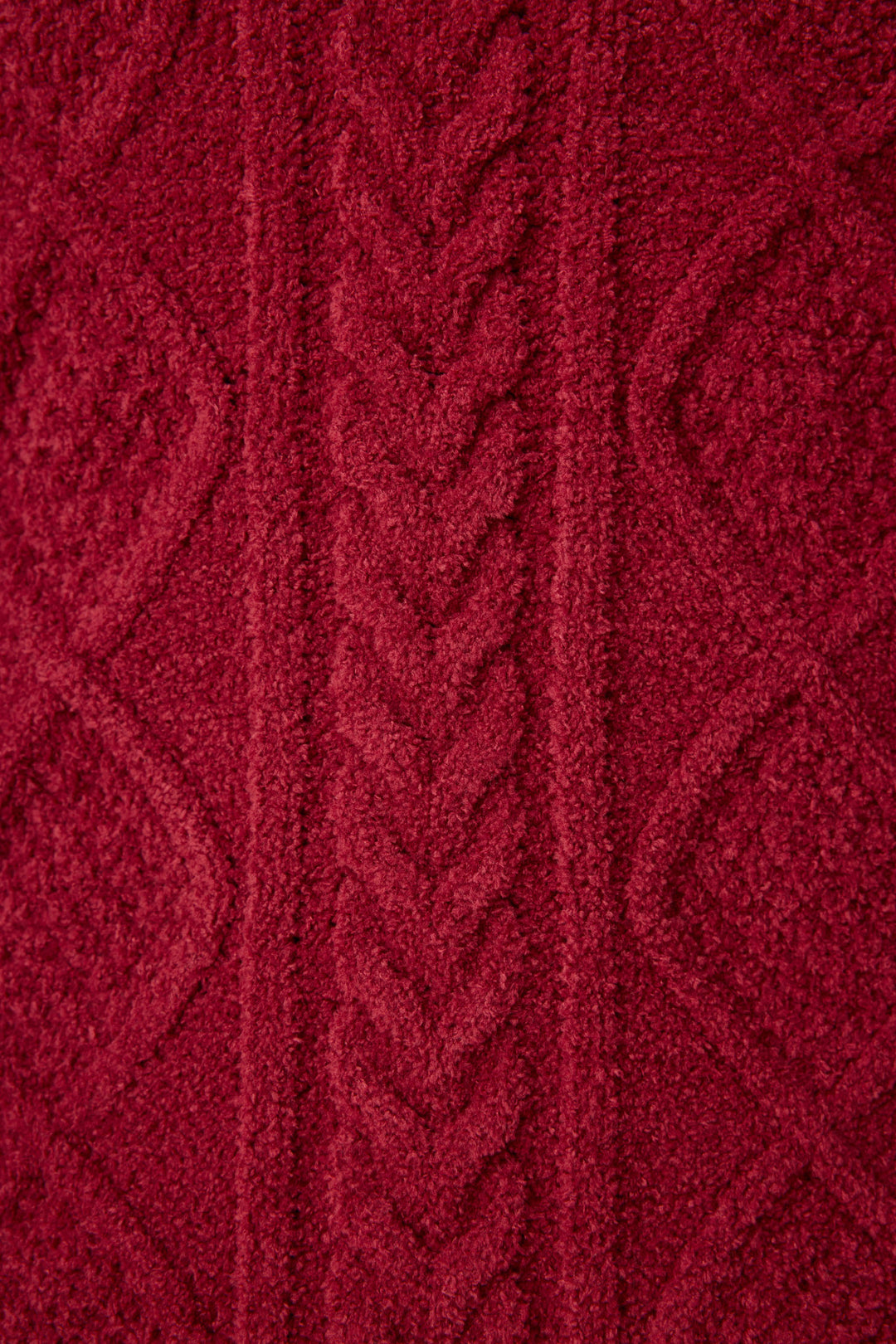 Close-up of the SOLID PJ SET COZY CHENILLE CABLE KNIT by P.J. Salvage, featuring soft red knit fabric with a central braided cable pattern and diamond shapes on either side.