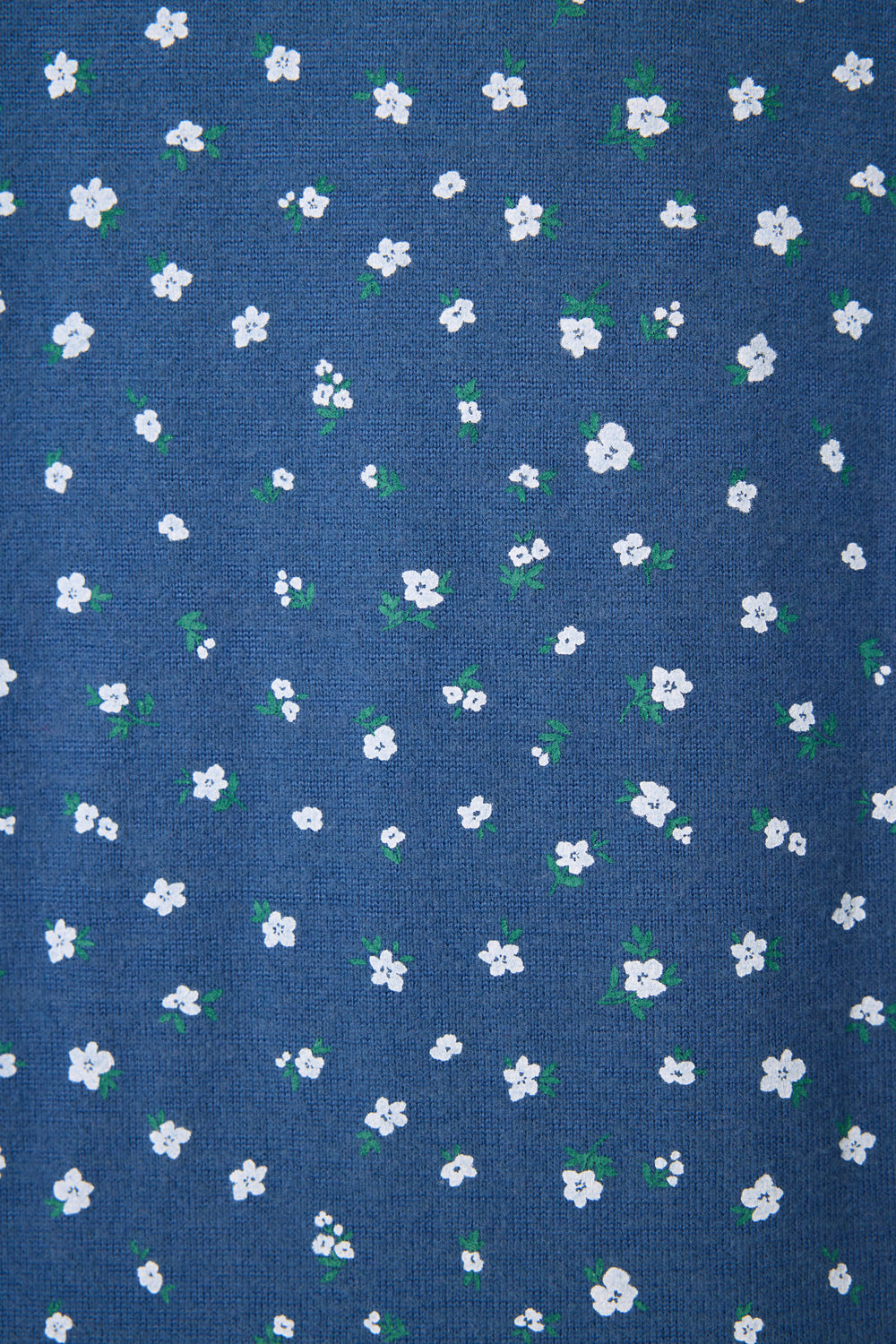 The P.J. Salvage Cozy Life Floral Long Sleeve Top features blue fabric adorned with small white flowers and green leaves in an even pattern.