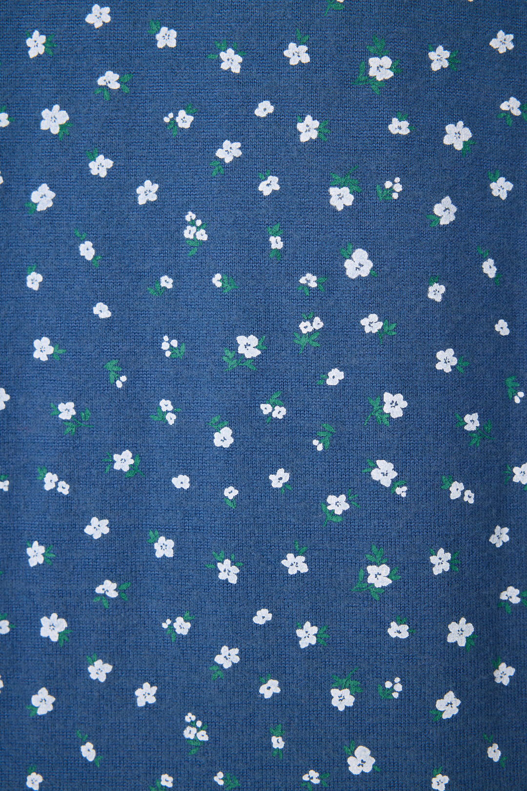 The P.J. Salvage Cozy Life Floral Long Sleeve Top features blue fabric adorned with small white flowers and green leaves in an even pattern.