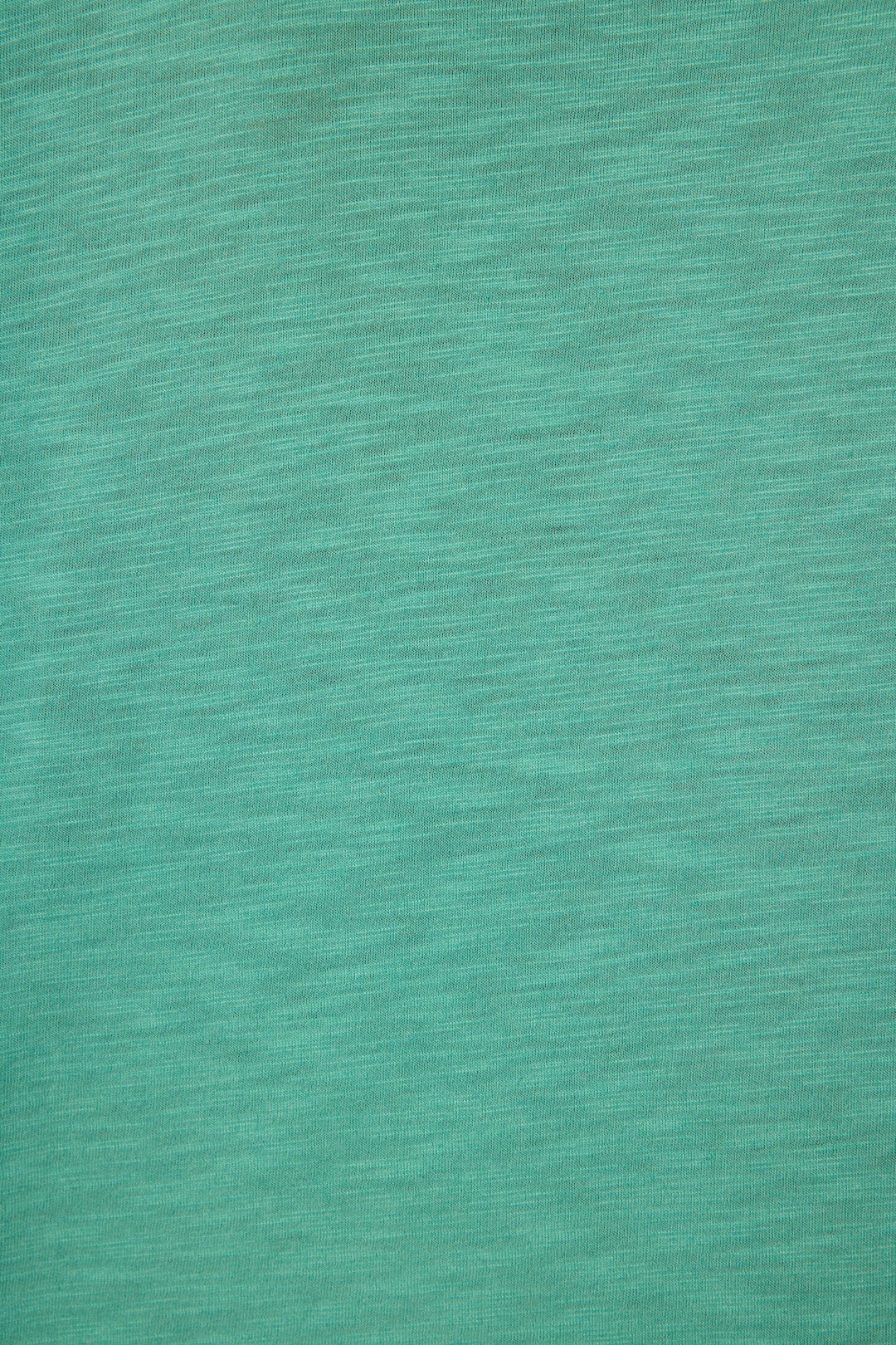 Close-up of the Cozy Life "Love" Graphic Long Sleeve Top by P.J. Salvage, featuring textured teal fabric with horizontal lines and a soft, mottled pattern.