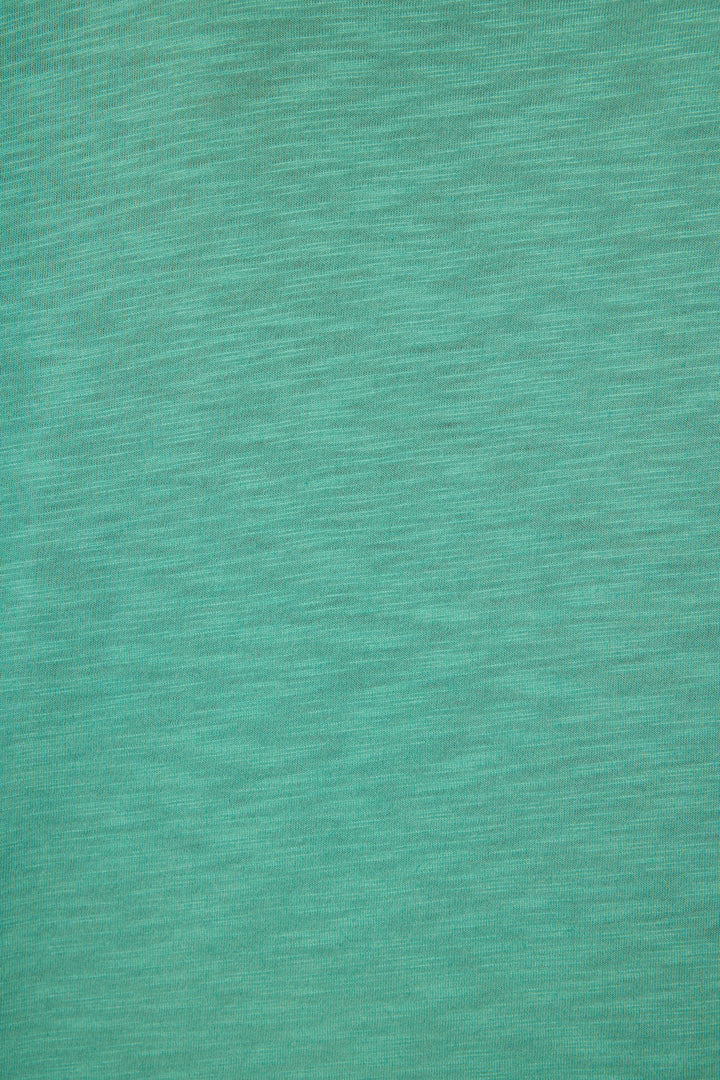 Close-up of the Cozy Life "Love" Graphic Long Sleeve Top by P.J. Salvage, featuring textured teal fabric with horizontal lines and a soft, mottled pattern.