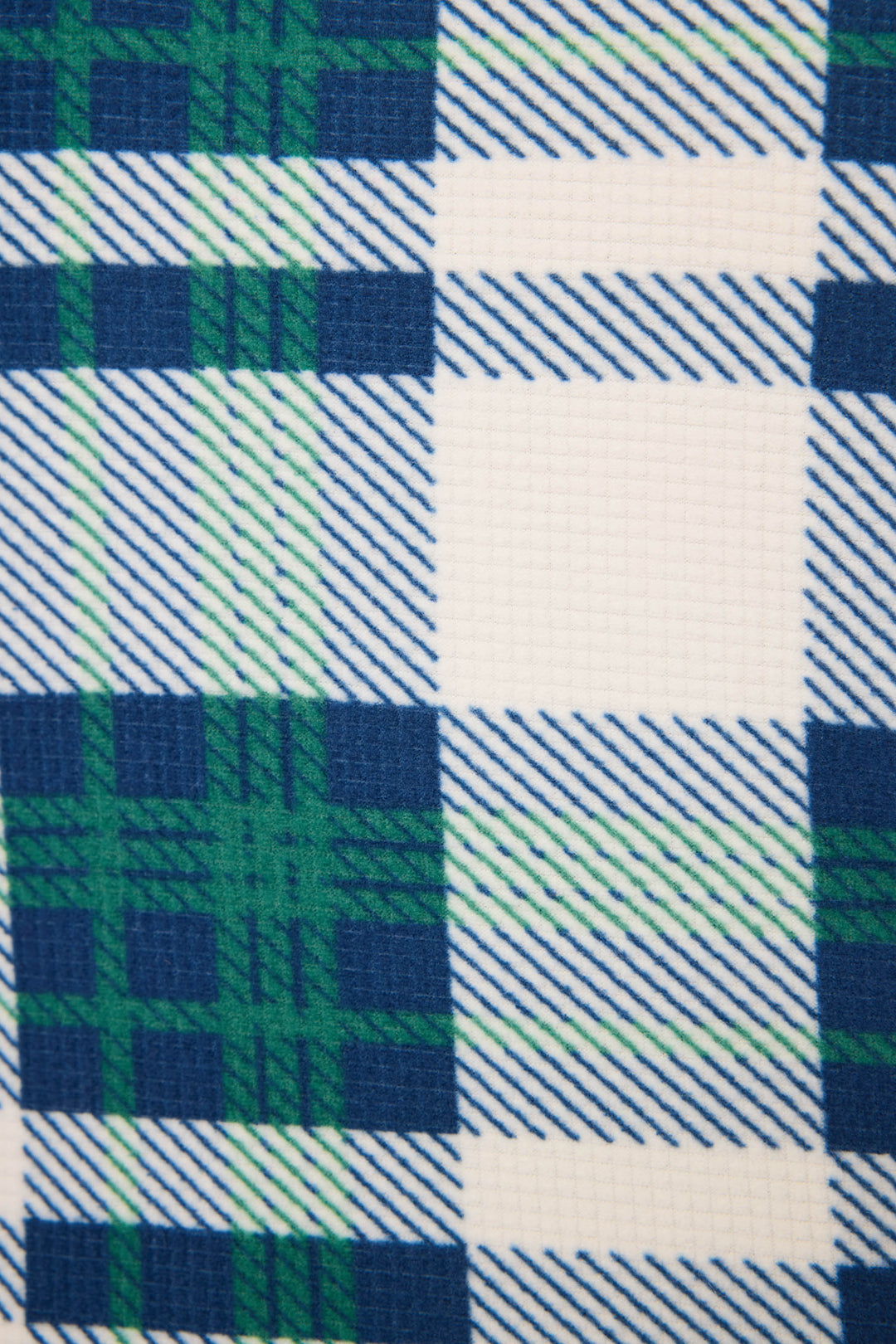 A close-up of the Cozy Life Plaid Velour Thermal Banded Pant by P.J. Salvage features a blue, green, and white plaid pattern with diagonal lines, showcasing the fabric's visible texture.