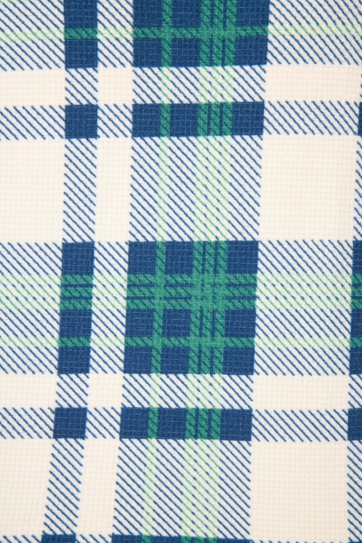 A close-up of the P.J. Salvage Cozy Life Plaid Velour Thermal Short shows its textured fabric with intersecting blue, green, and white lines in a classic grid pattern.
