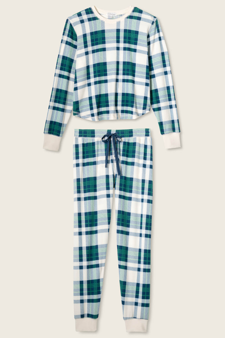 The P.J. Salvage Cozy Life Plaid Velour Thermal PJ Set features a blue, green, and white plaid two-piece design with a long-sleeve top and matching pants, both accented with white cuffs, waistband, and a drawstring waist.