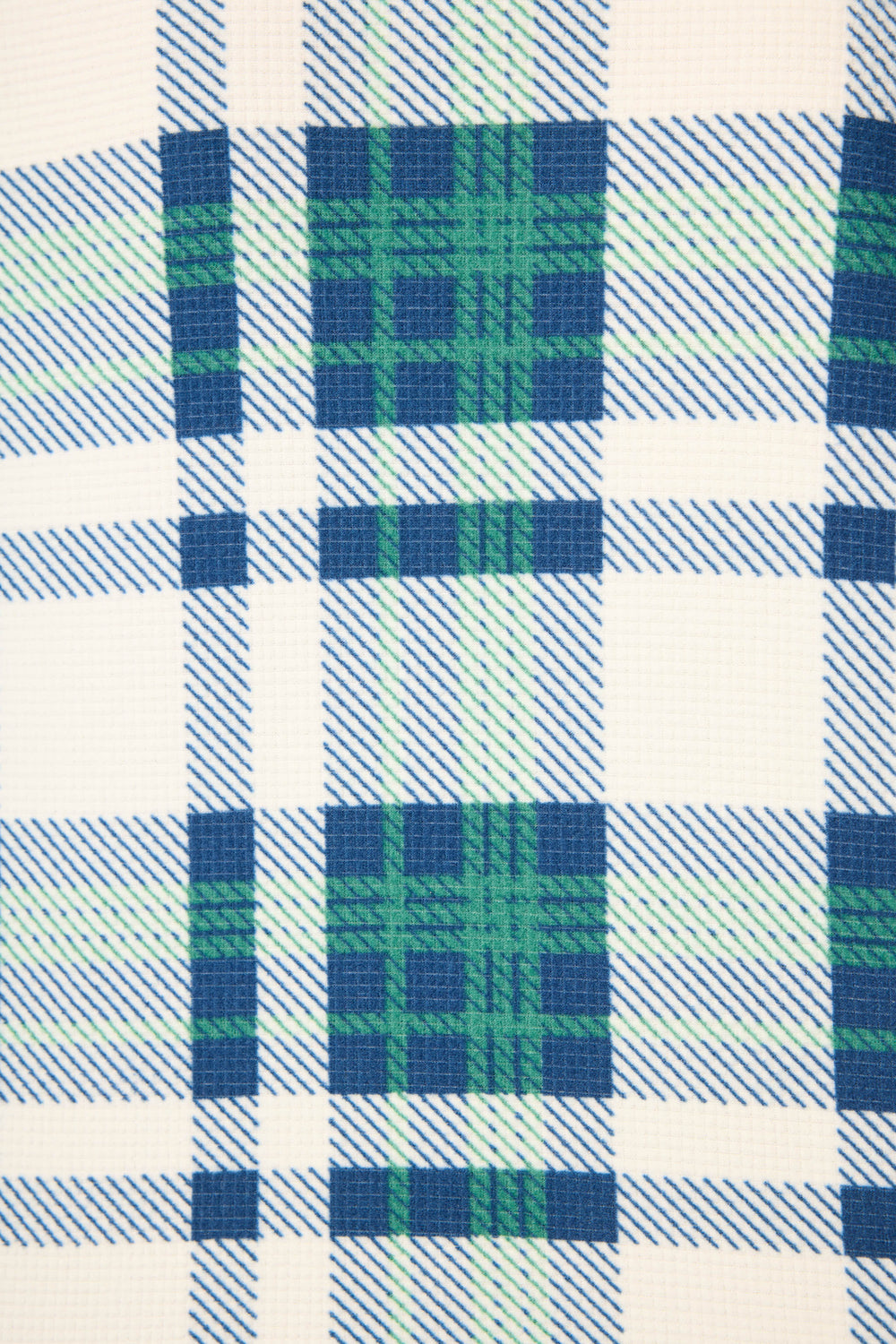 Close-up of the Cozy Life Plaid Velour Thermal PJ Set by P.J. Salvage, featuring soft fabric in a plaid pattern with blue and green lines on a white background. The velour texture is clearly visible.