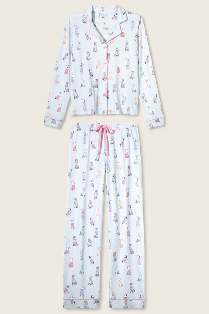 The P.J. Salvage Doggone Cold Dog Print Pointelle Plus Size PJ Set features light blue, button-up long-sleeve top and pants with colorful dog prints, pink piping trim, and a pink drawstring waistband.