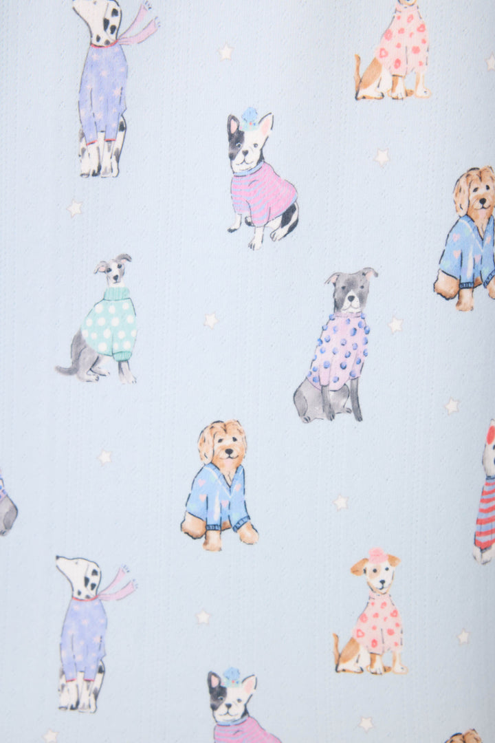 The Doggone Cold Dog Print Pointelle Lounge Set by P.J. Salvage features dogs in various poses and colors, wearing colorful sweaters and hats on a light blue background with small white stars.