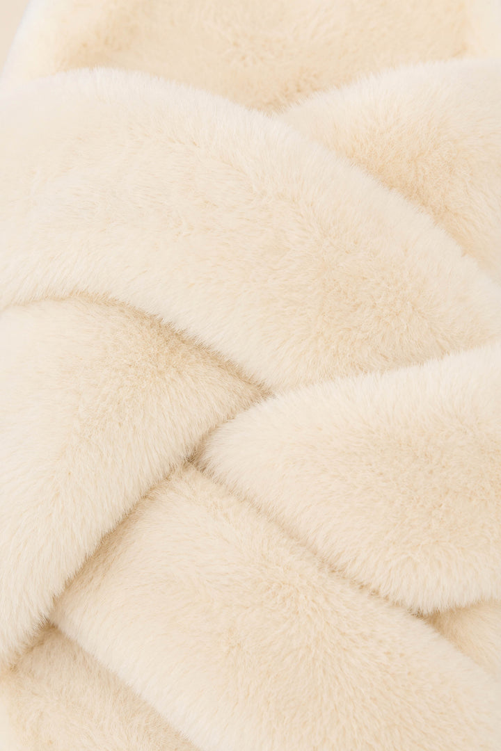 Close-up of the soft, creamy beige faux fur material of the P.J. Salvage White Faux Fur Slippers, arranged in overlapping diagonal folds to create a luxurious and cozy texture.