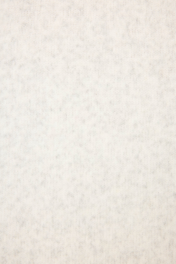 A close-up of the P.J. Salvage Espresso Til Prosecco Snuggle Sweater’s light gray, soft, fuzzy fabric shows its even, plush texture and subtle mottled pattern—perfect for cozy comfort.