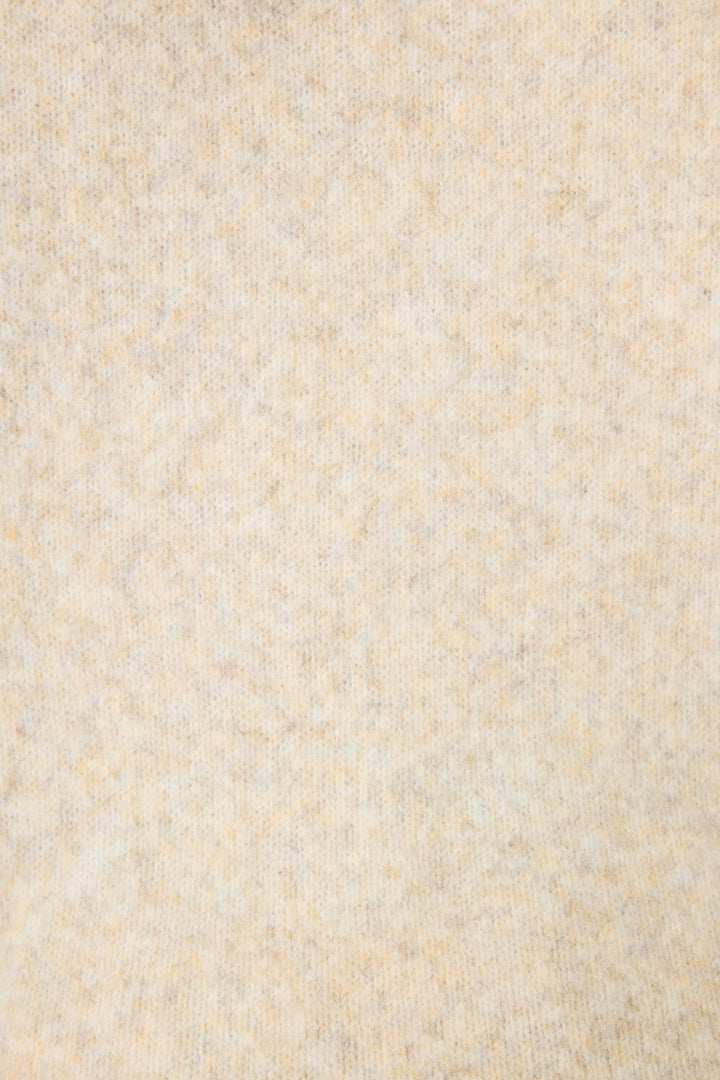 Close-up of the Teddy Bear Graphic Snuggle Sweater by P.J. Salvage, showing its soft light beige fabric with a subtle mottled texture and slightly fuzzy appearance, free from distinct patterns or visible objects.