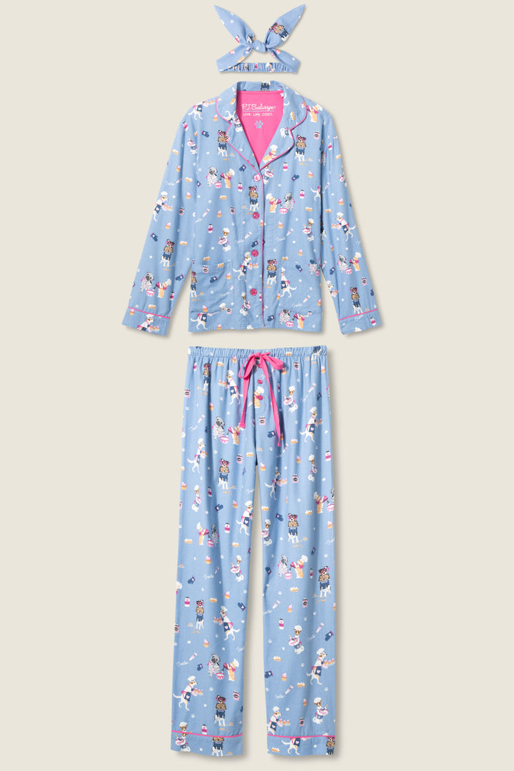 The P.J. Salvage 3-Piece Set WILD PJ SET FLANNELS PLUS includes a blue long-sleeve button-up shirt, matching pants with a pink drawstring, and a headband—all featuring playful cats and dogs in winter outfits.