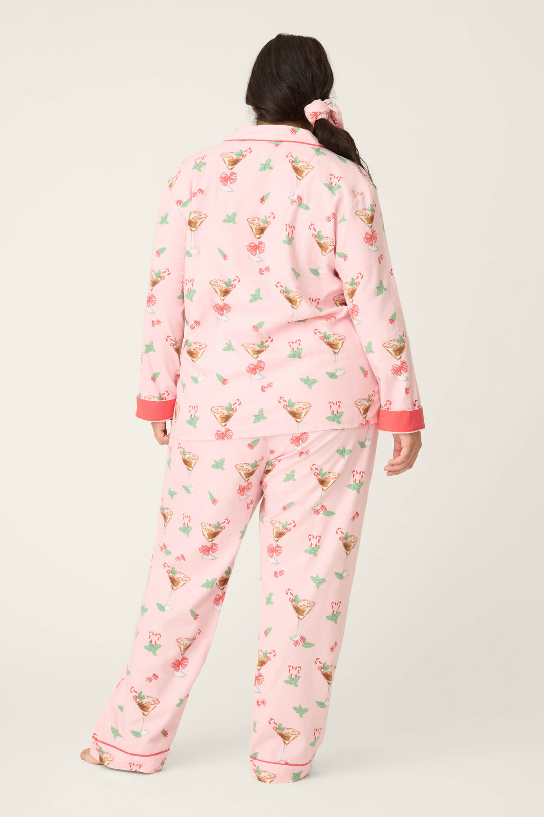 A woman wears the P.J. Salvage Tini Time Drink Print Flannel Plus Size PJ Set.