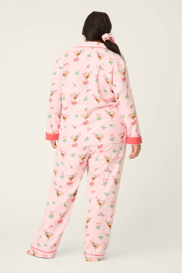 A woman wears the P.J. Salvage Tini Time Drink Print Flannel Plus Size PJ Set.