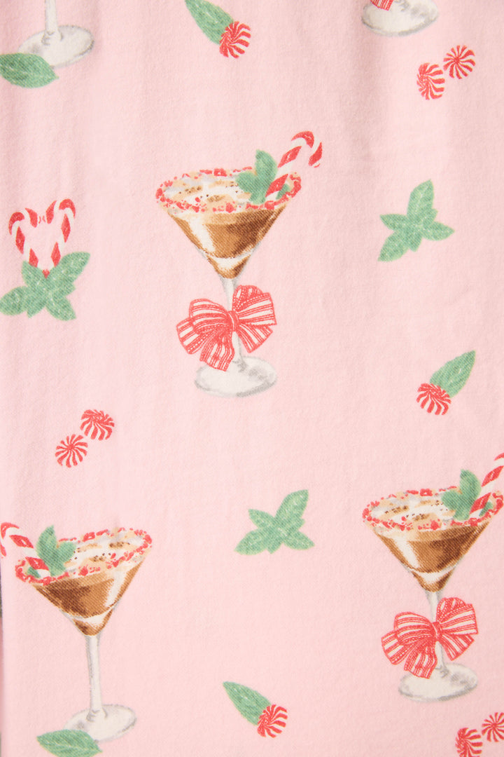 The Tini Time Drink Print Flannel Plus Size PJ Set by P.J. Salvage features a pink fabric with martini glasses, candy canes, red bows, green mint leaves, and peppermint candies in a festive repeating pattern.