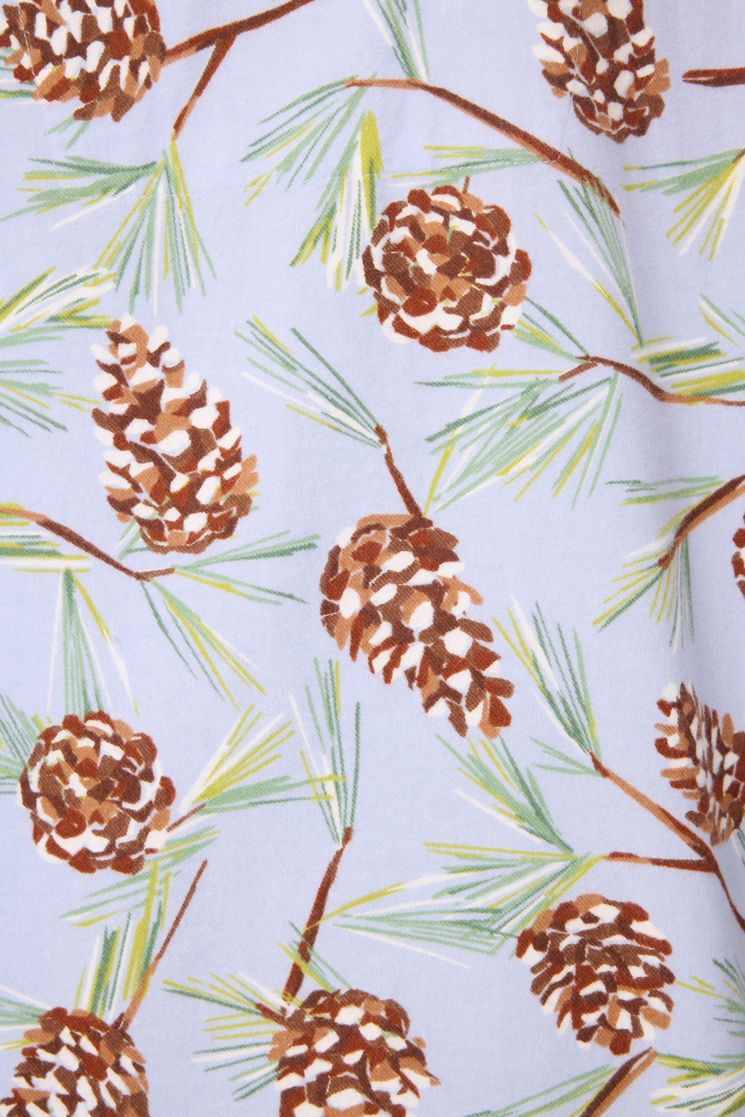 A close-up of the Feelin' Pine Pinecone Print PJ Set by P.J. Salvage, featuring a fabric pattern of brown pinecones and green pine needles on a light blue background.