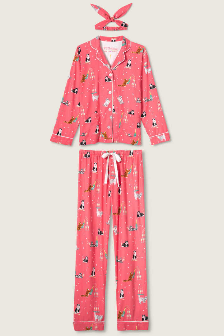 The P.J. Salvage "Let's Get Fizzical Cat Print Flannel PJ Set" features a matching pink button-up top, long pants, and headband with a festive cat print on a light background.