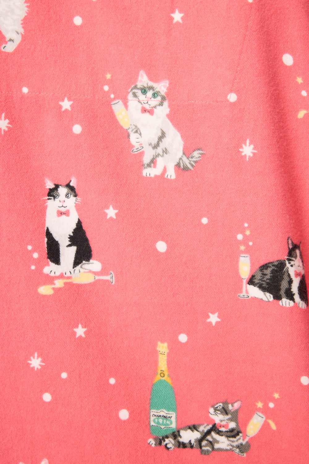 The Let’s Get Fizzical Cat Print Flannel PJ Set by P.J. Salvage features pink fabric with cats in party accessories—champagne glasses, bottles, bow ties—and scattered white stars.