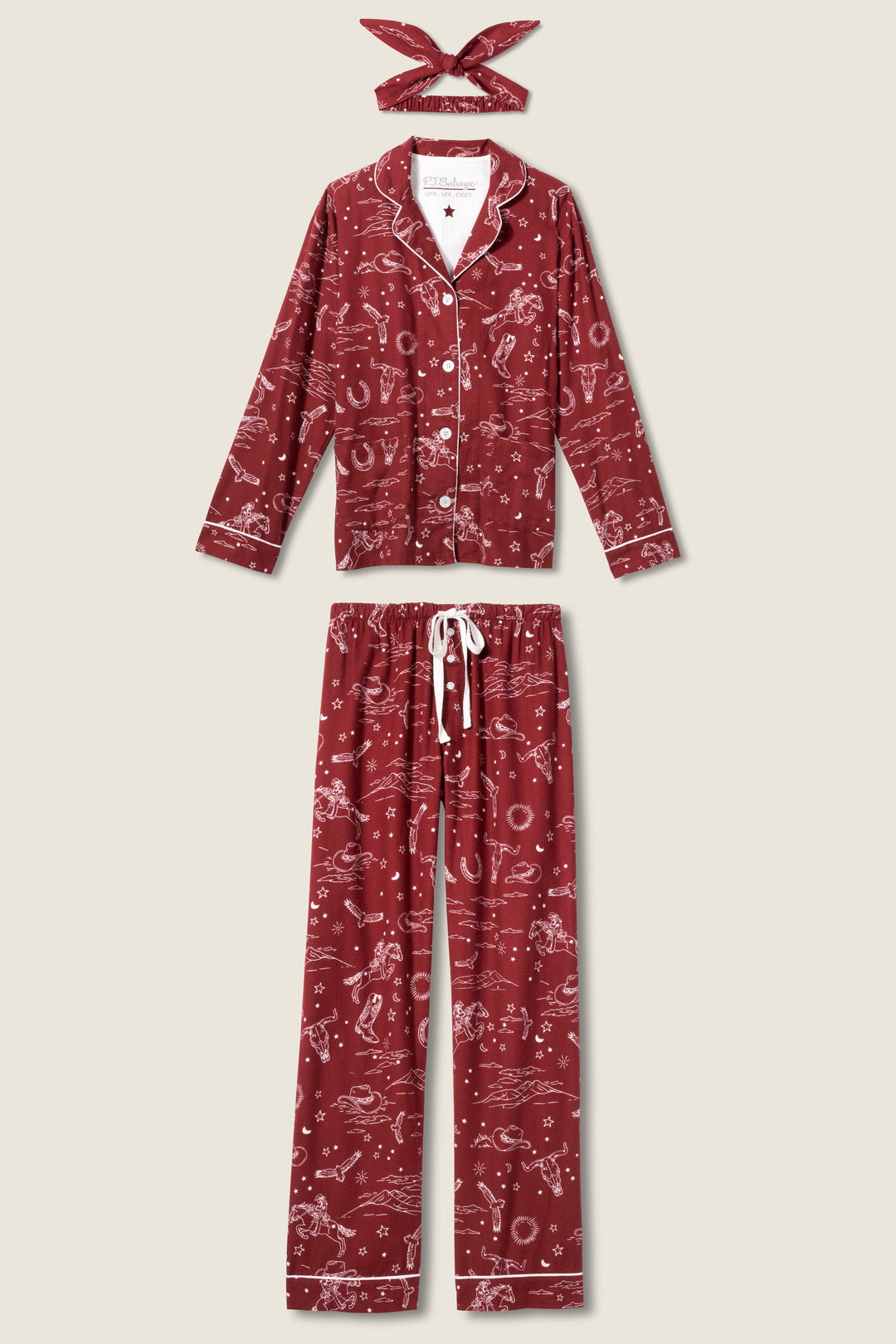 The P.J. Salvage 3-Piece Set PAISLEY PJ SET FLANNELS features a maroon pajama set with white Western paisley prints, including a long-sleeve button-up shirt, drawstring pants, and a matching headband displayed on a beige background.