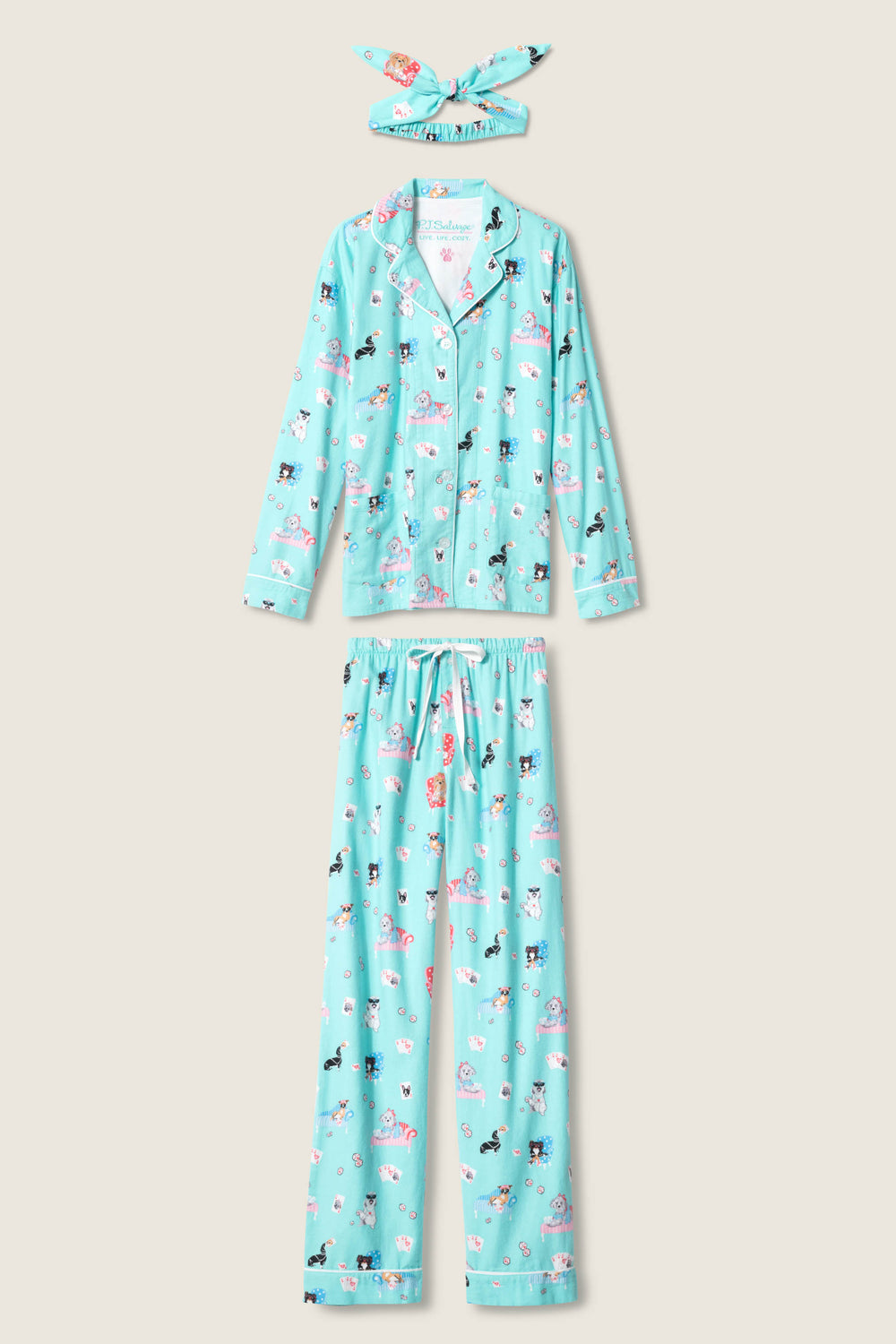 The P.J. Salvage This Is How I Roll Dog Print Flannel PJ Set is a three-piece set with a long-sleeve button-up shirt, elastic-waist pants, and matching headband in light blue dog print flannel.