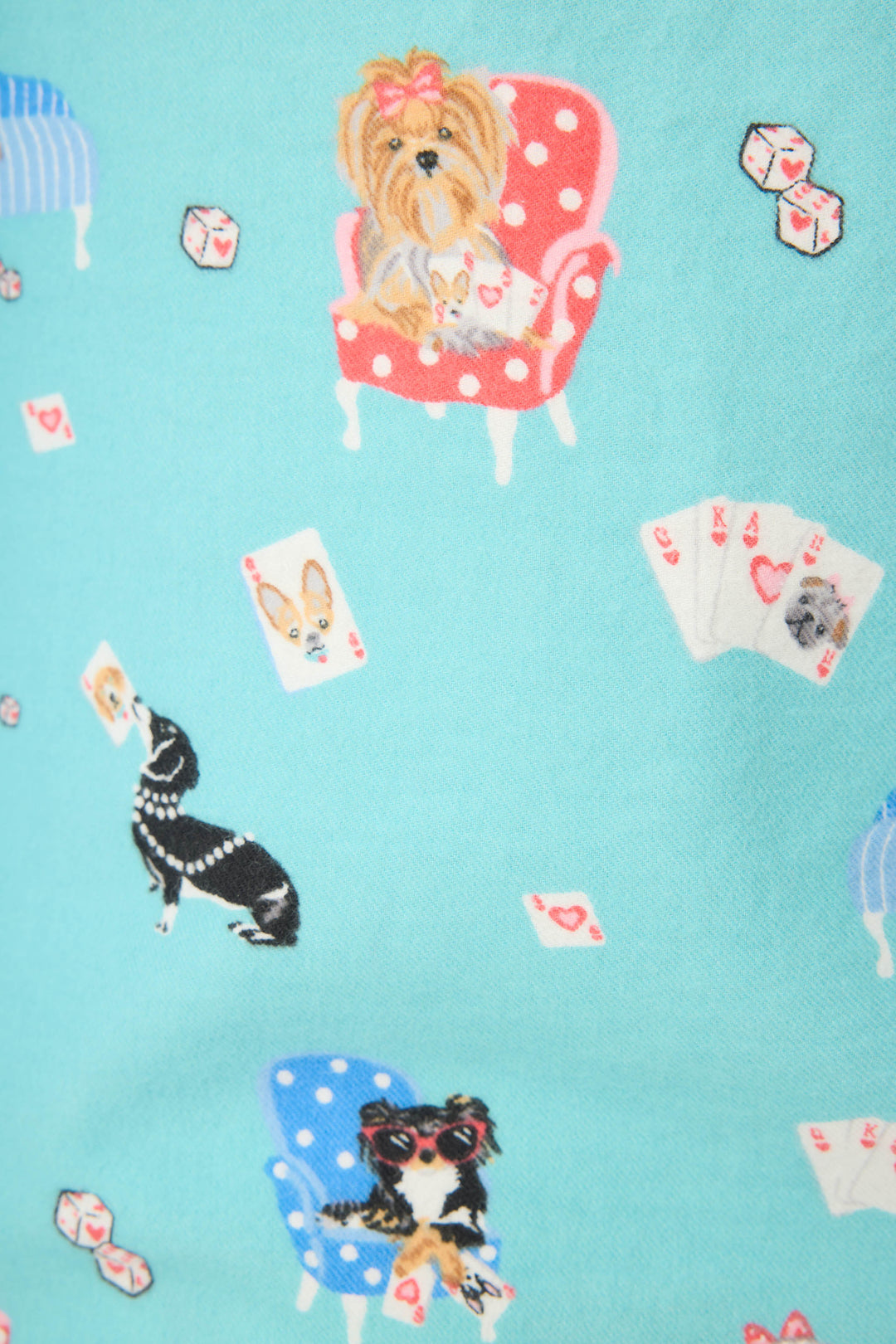 The P.J. Salvage This Is How I Roll Dog Print Flannel PJ Set features illustrated dogs with playing cards and dice on a light blue background, creating a playful, patterned design.