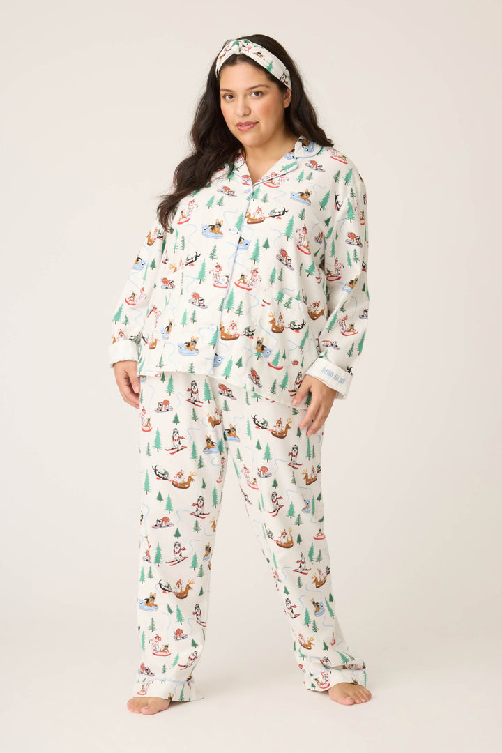 A person faces forward in the P.J. Salvage Sleigh All Day Winter Print Flannel Plus Size PJ Set with a matching headband, set against a plain light background.