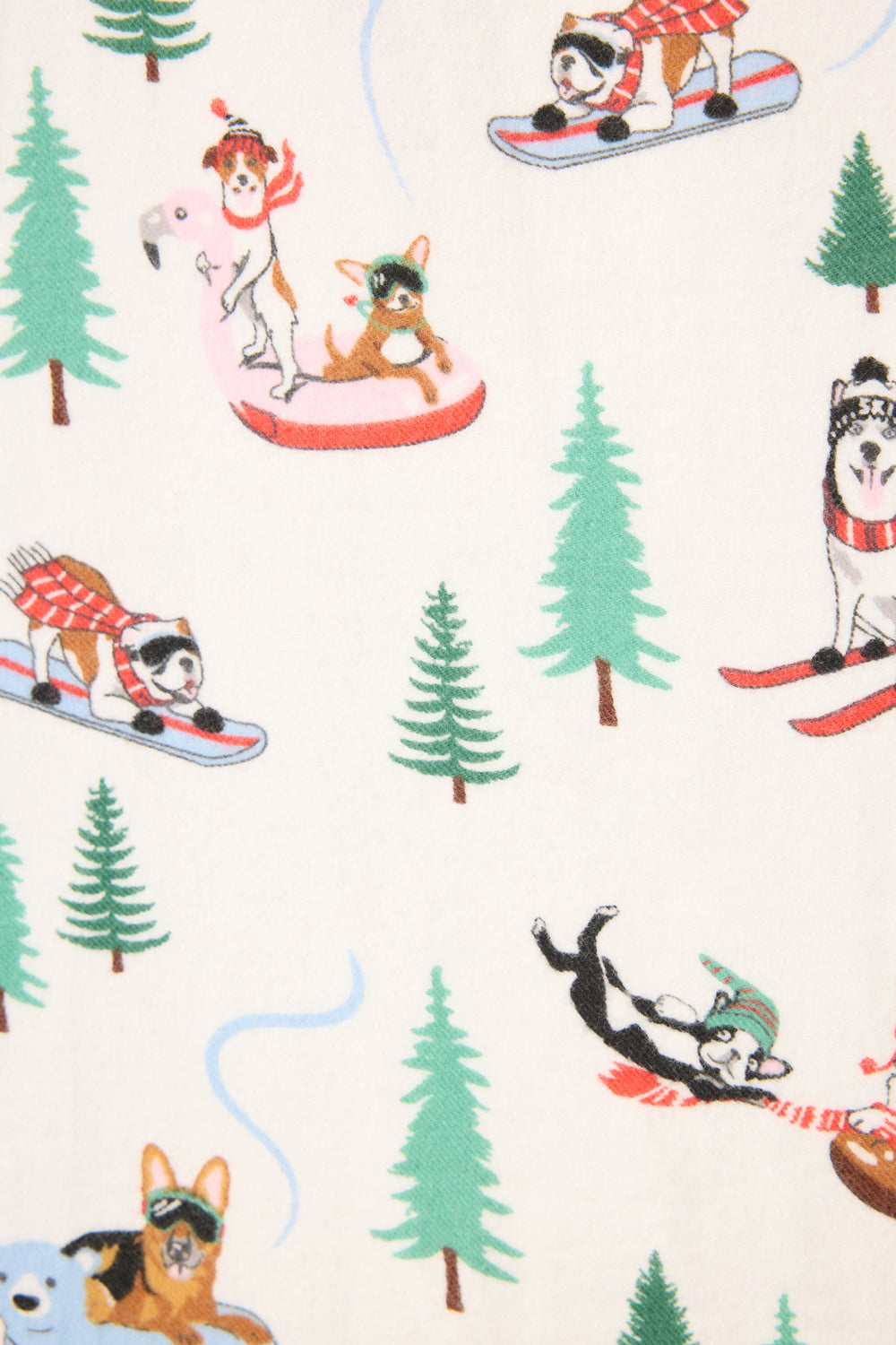 The Sleigh All Day Winter Print Flannel PJ Set by P.J. Salvage features playful illustrations of dogs skiing, snowboarding, and riding an inflatable flamingo amid green pine trees on a crisp white background.