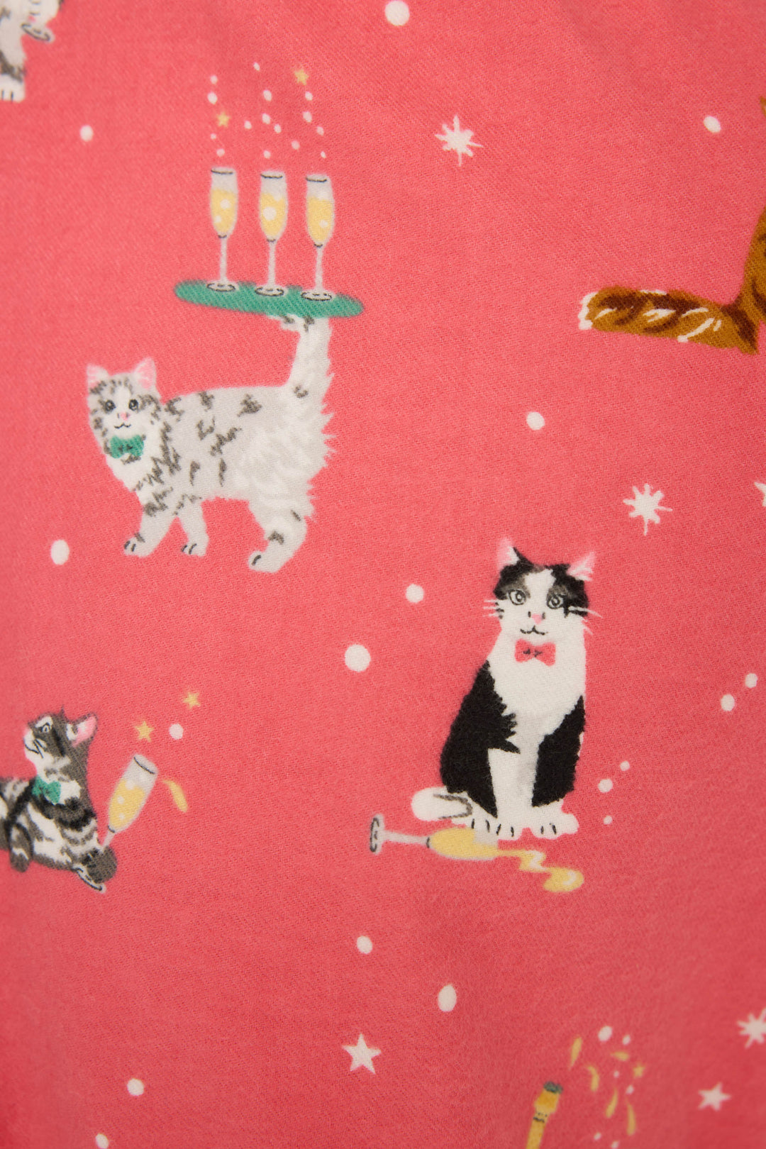 The Let's Get Fizzical Cat Print Flannel Pant by P.J. Salvage features pink fabric with playful cats, champagne glasses, a bow-tied cat, a gray cat under a tray of champagne, and white dot "bubbles" scattered across the pattern.