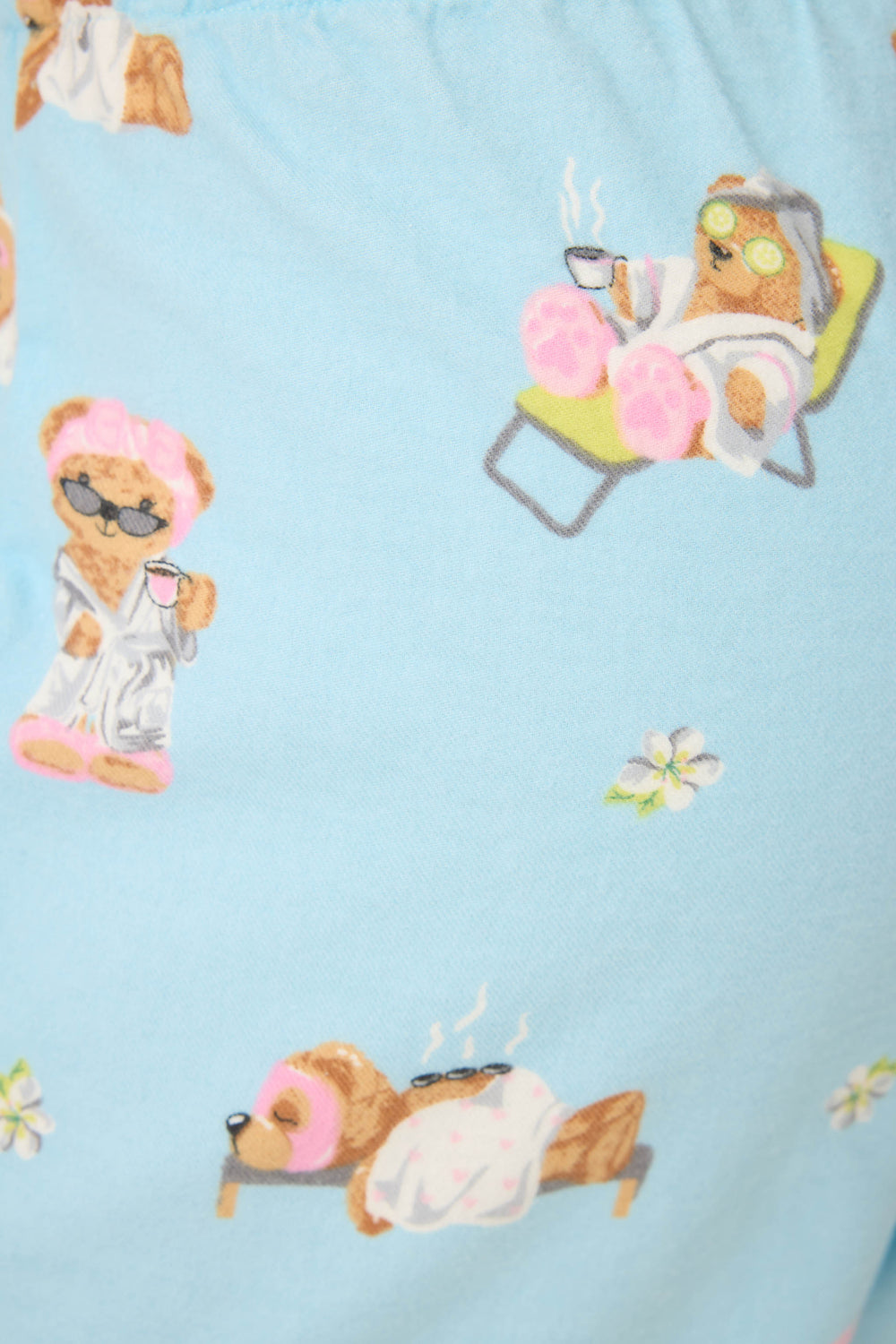 The Beary Cute Bear Print Flannel Pants by P.J. Salvage feature cartoon bears in spa robes and sunglasses, relaxing with drinks on lounge chairs and massage tables, set on a light blue background with tiny white flowers.