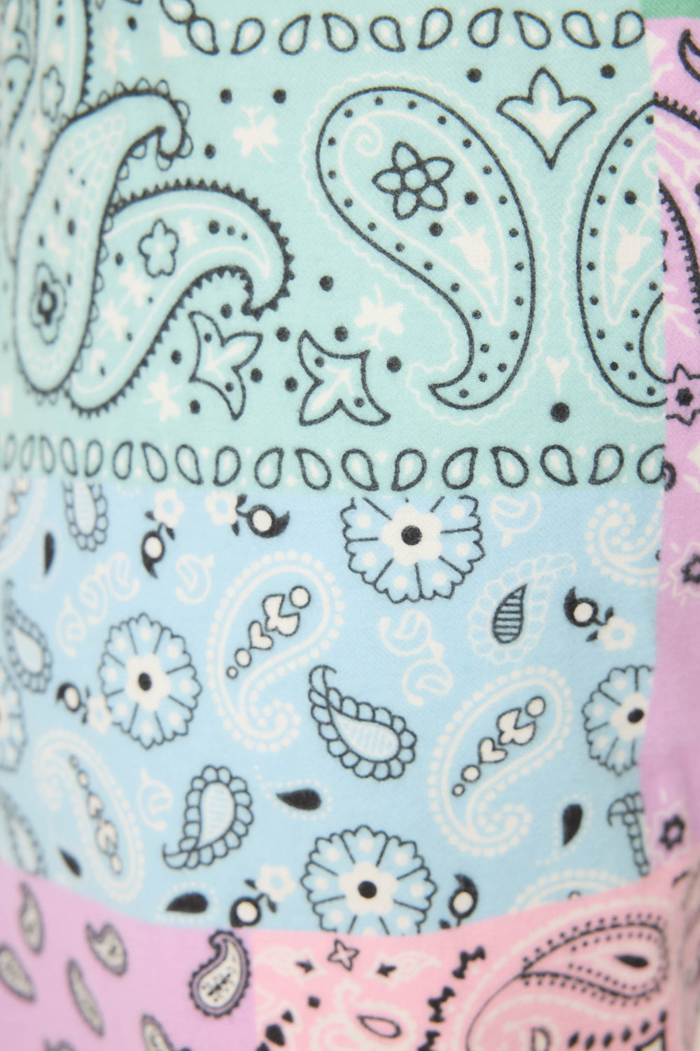 Close-up of P.J. Salvages Howdy Honey Paisley Print Flannel Pant, featuring a pastel paisley and floral pattern in mint green, light blue, and pink with black and white outlines and decorative details.