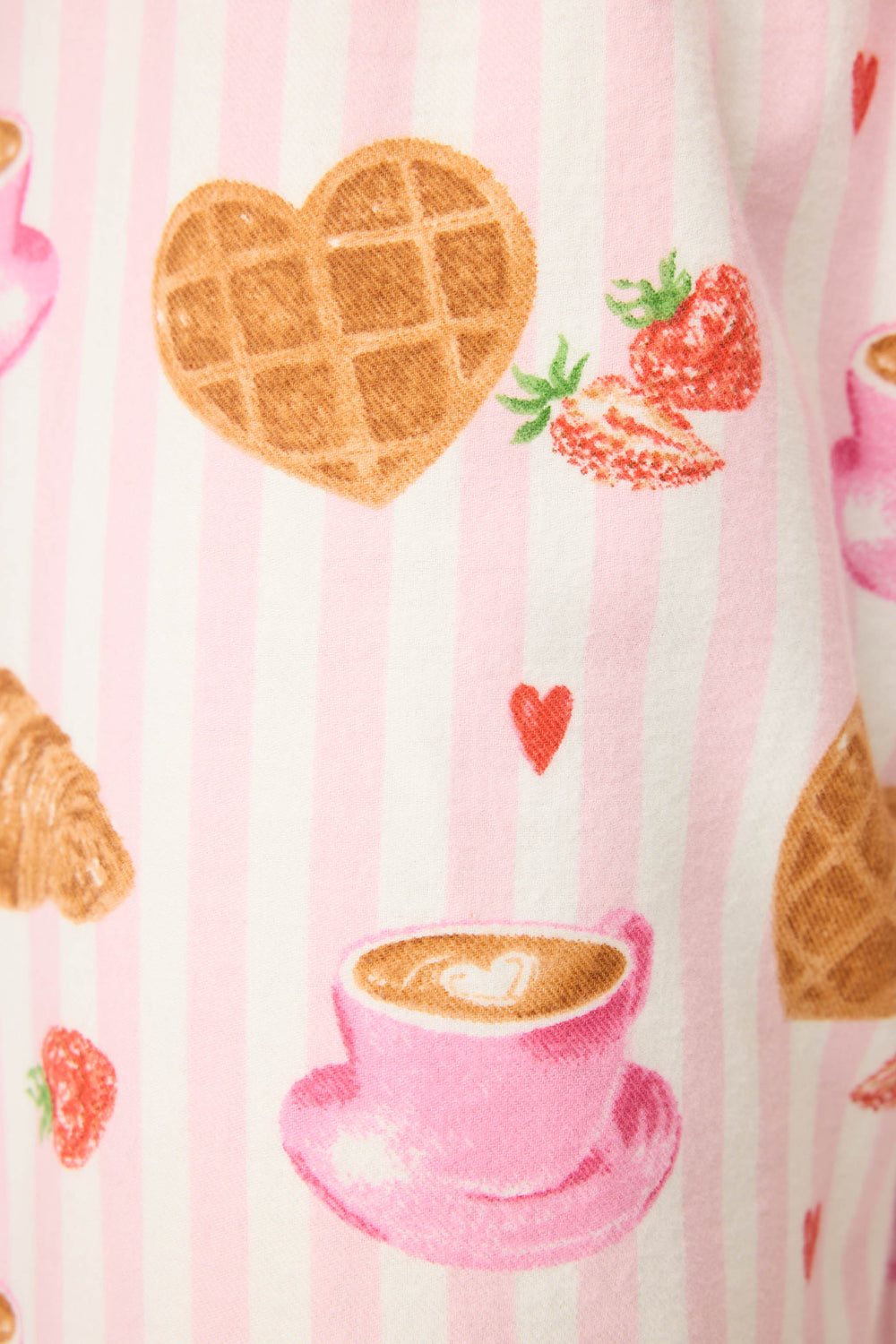 The P.J. Salvage Brunch Club Breakfast Print Flannel Pant features pink and white vertical stripes with printed heart-shaped waffles, strawberries, croissants, pink coffee cups, and small red hearts.