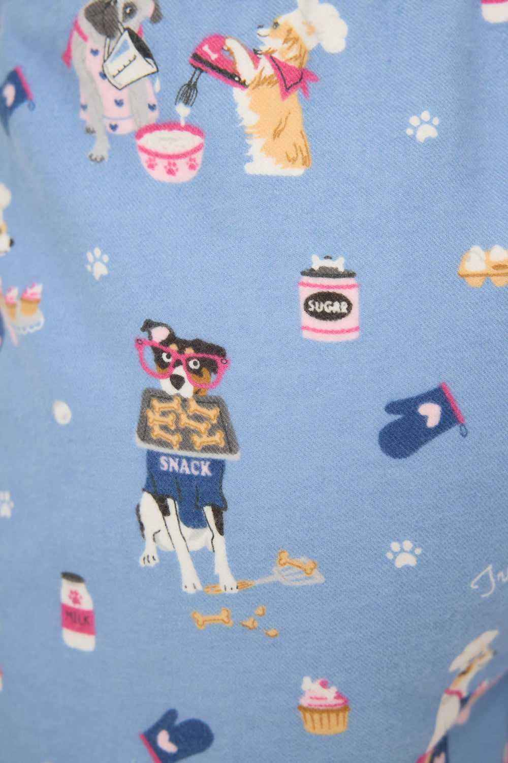 The P.J. Salvage DOGS SHORT FLANNELS features a playful illustration of dogs baking on a blue background, with one dog in glasses and a SNACK apron holding biscuits, surrounded by baking items and treats.