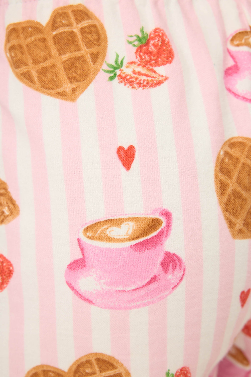 The P.J. Salvage Brunch Club Breakfast Print Flannel Shorts feature pink and white stripes with heart-shaped waffles, strawberries, pink coffee cups with latte art, and small red hearts.