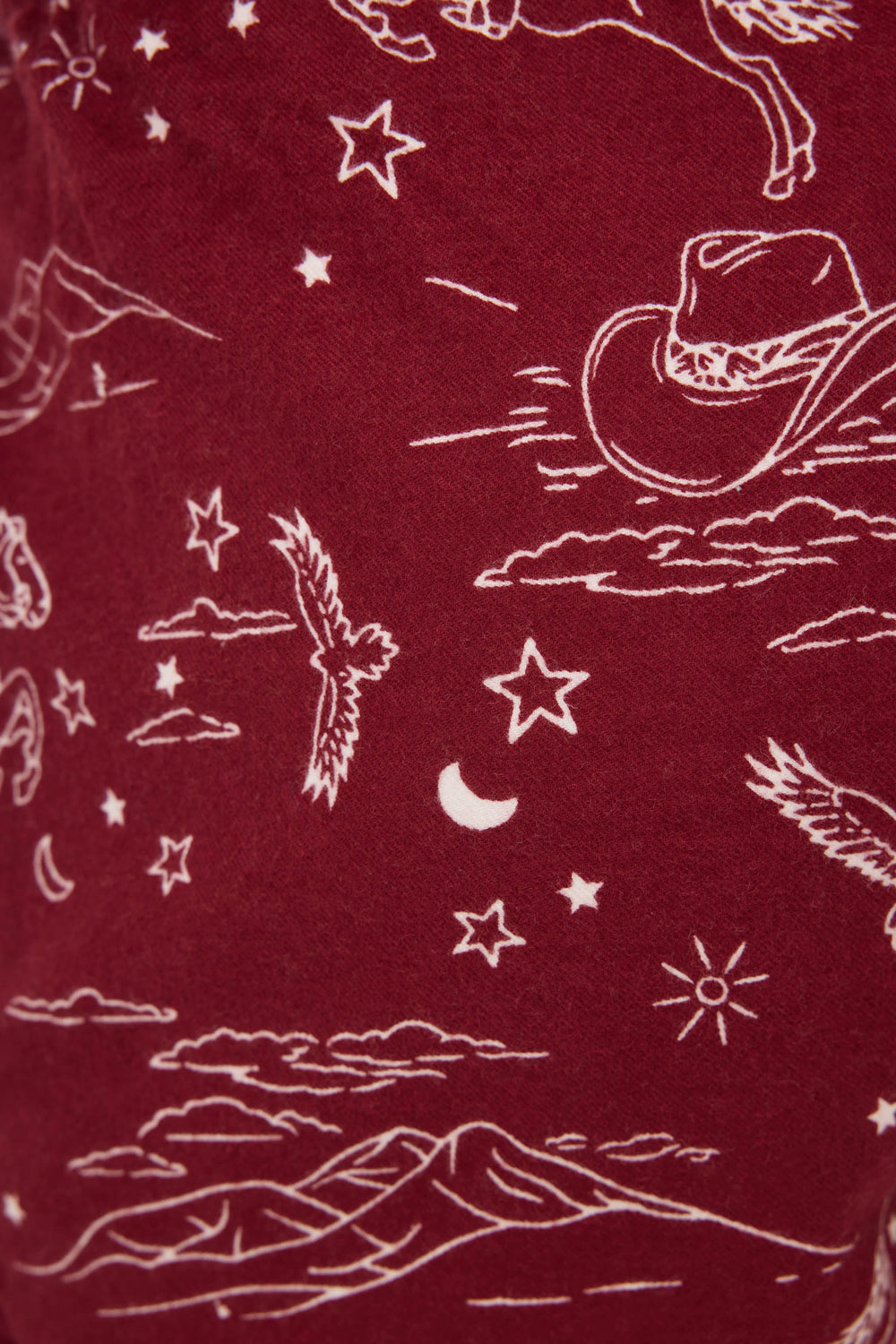 SHORT FLANNELS by P.J. Salvage: Maroon fabric with a white Western print featuring cowboy hats, horses, mountains, stars, clouds, a crescent moon, birds, and a sun.