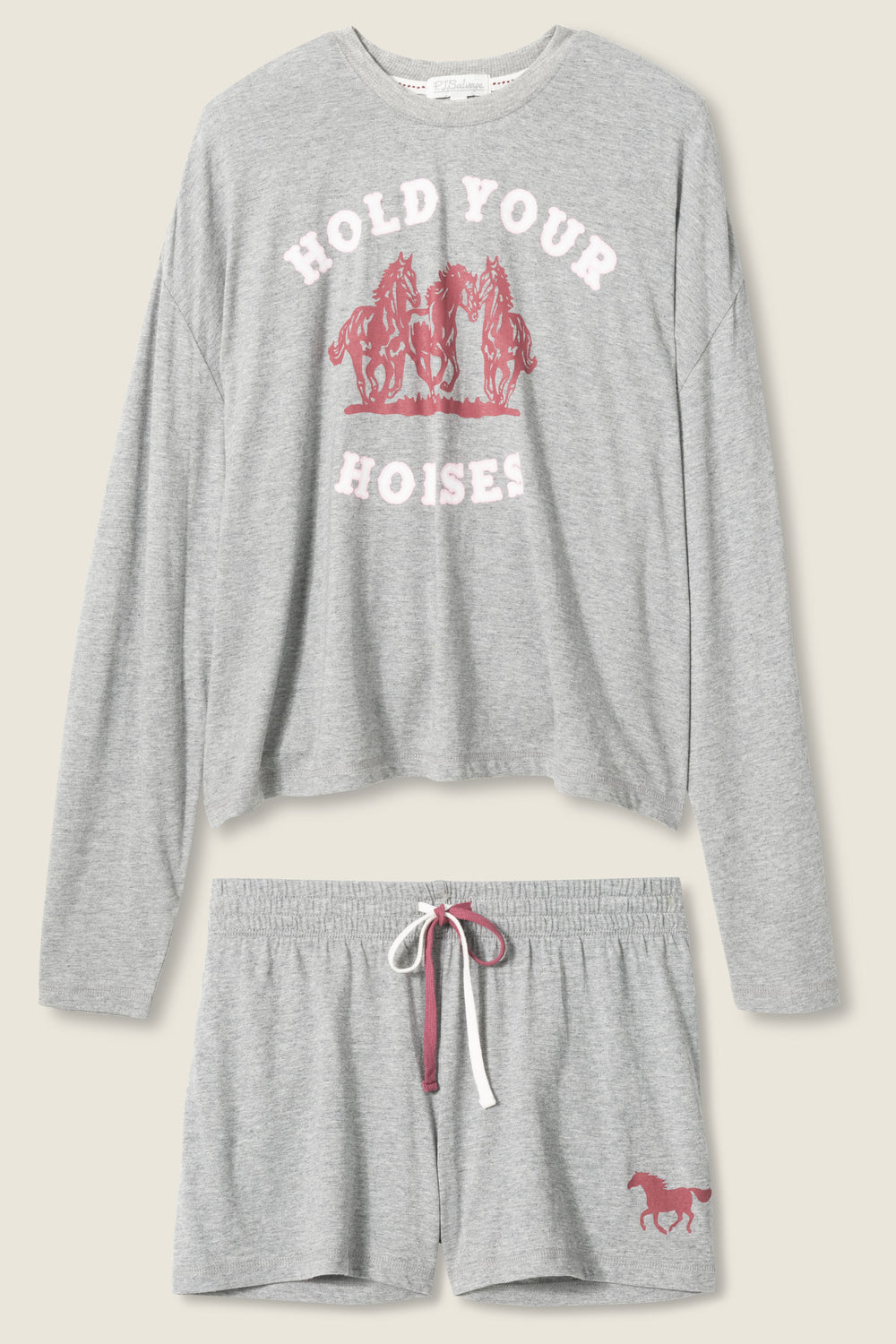 The P.J. Salvage Short Set HOLD YOUR HORSES PJ SET includes a gray long-sleeve top with pink “HOLD YOUR HORSES” and horse graphics, plus matching gray drawstring shorts with a small pink horse graphic on the left leg.