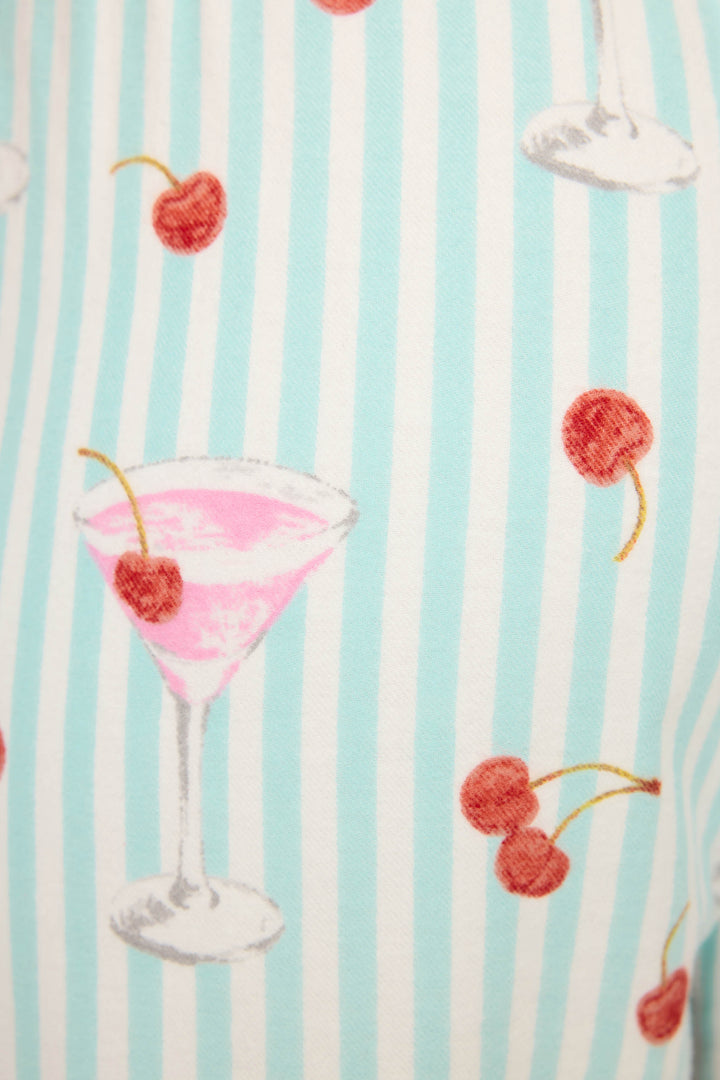 The DOGS PANT FLANNELS by P.J. Salvage feature pink cocktails in martini glasses with cherries and pairs of red cherries on vertical light blue and white stripes.