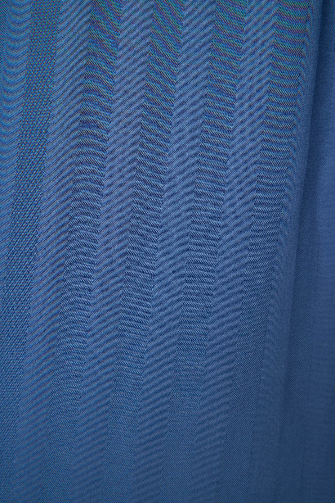 A close-up of the La Rose Striped Long Sleeve Top by P.J. Salvage shows blue jacquard sateen fabric with vertical stripes and a textured pattern, its soft folds highlighted—ideal for this stylish button-down pajama top.