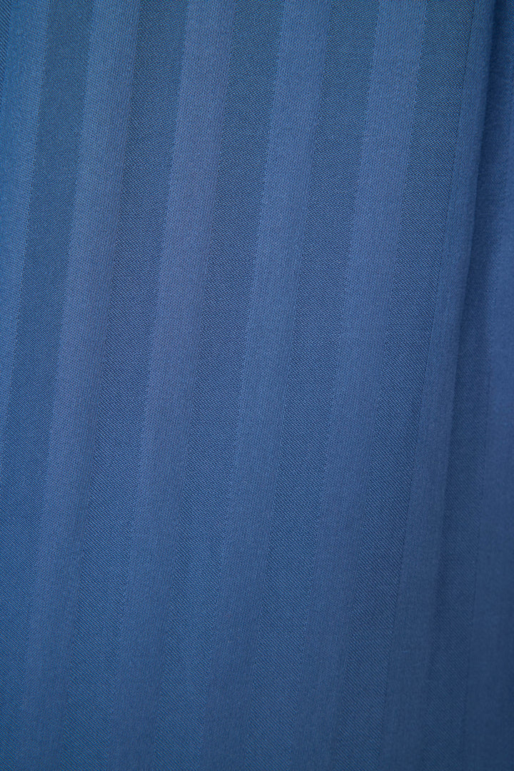 A close-up of the La Rose Striped Long Sleeve Top by P.J. Salvage shows blue jacquard sateen fabric with vertical stripes and a textured pattern, its soft folds highlighted—ideal for this stylish button-down pajama top.